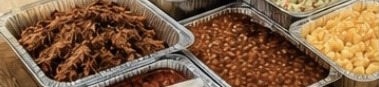 Catering trays of pulled pork, baked beans and macaroni and cheese
