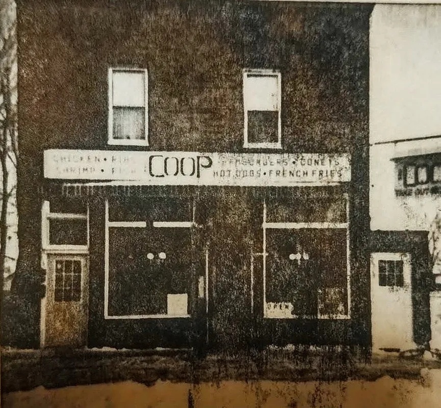 The original Coop storefront, its sign listing chicken, ribs, hamburgers, coneys, hot dogs and french fries